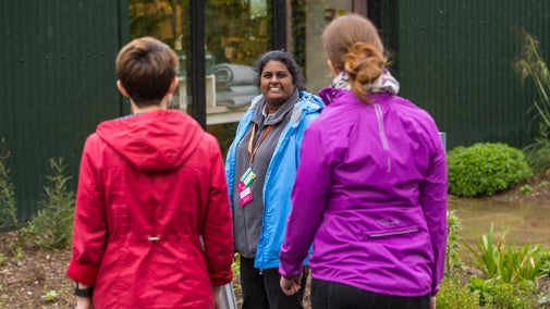 Staff member welcoming visitors at Coleton Fishacre, Devon